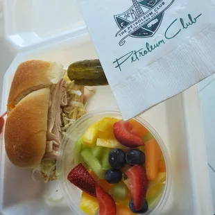 a sandwich and fruit salad