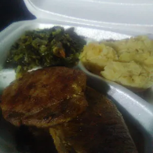 Pork chops, baked potatoes and greens
