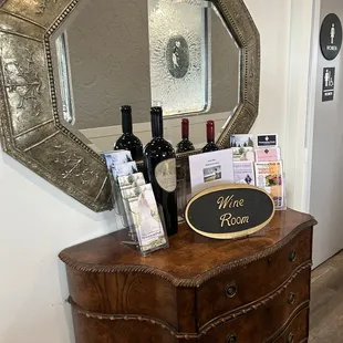 a dresser with wine bottles on it