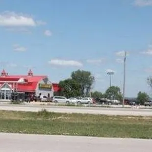 a view of a gas station from the side of the road