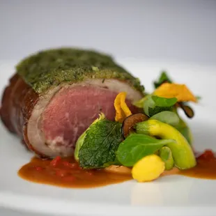 LAMB SADDLE -  ROASTED EGGPLANT PURÉE, SQUASH BLOSSOMS, BELL PEPPER JUS