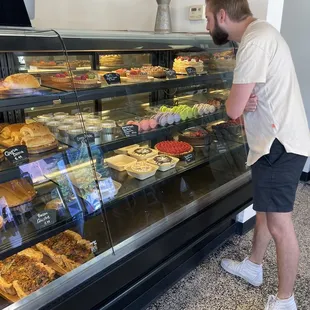 a man standing in front of a display case