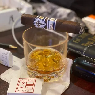 a glass of whiskey and a cigar