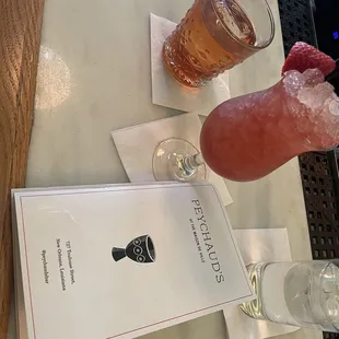 a drink and a menu on a table