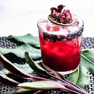 a cocktail with a garnish