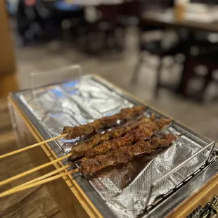 skewered meat on a grill