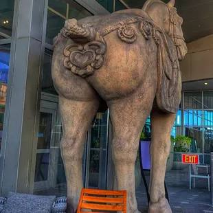 The back side of the horse on the patio.