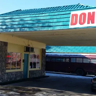 a car parked in front of a donut shop