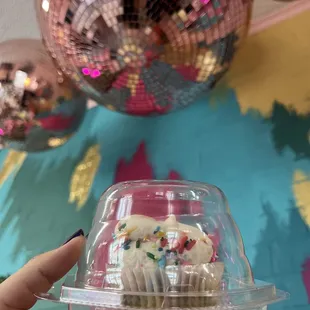 a cupcake in a plastic container