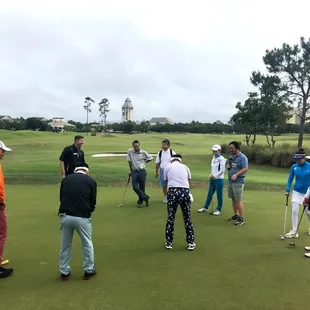 A group golf clinic, working on the putting stroke.