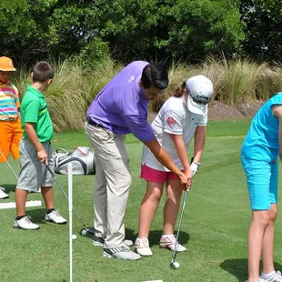 A few youngsters learning the game of golf during a Junior Golf Camp.