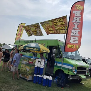 a group of people standing in front of a food truck