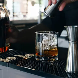 a bartender pouring a drink