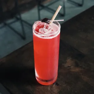 a drink with a straw and a cherry garnish