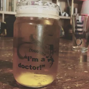  a jar of liquid on a table