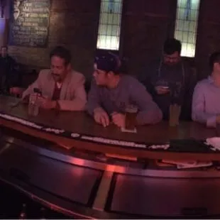  a group of people sitting at a bar