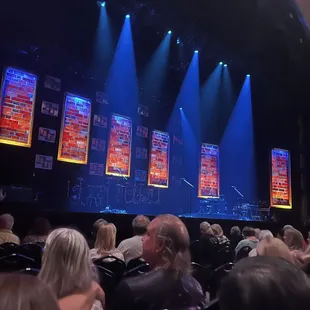 a crowd of people sitting in front of a stage