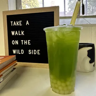 a green drink in a plastic cup