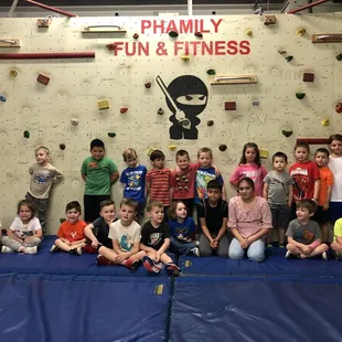 Group birthday photo along the climbing wall - the birthday child gets to sign the wall!