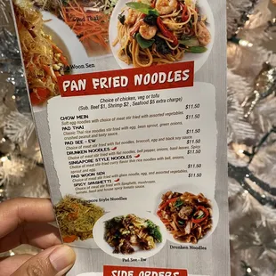 a hand holding a menu for a restaurant