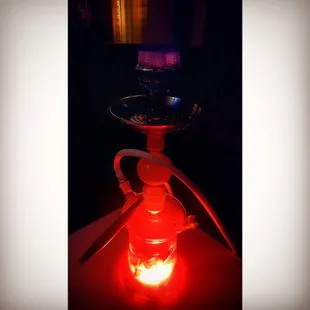 a glass hook with a red light