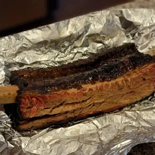 a rack of ribs wrapped in tin foil