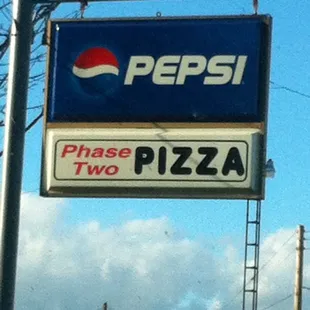 All white building with wooden porch, steps and ramp access.