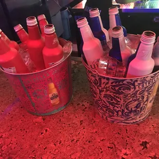 a bucket full of bottles of alcohol