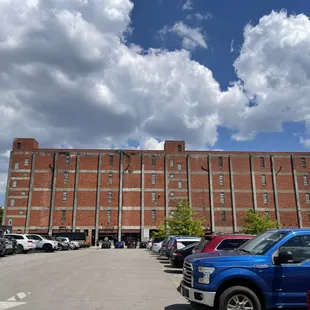 a parking lot in front of a brick building