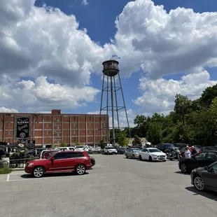 a parking lot with a water tower in the background