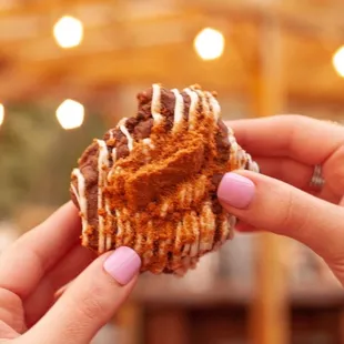 a hand holding a pastry
