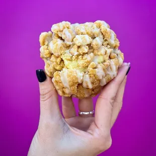 a hand holding a doughnut