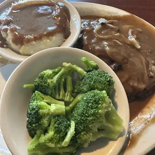Salisbury steak, mashed potatoes with gravy, and steamed broccoli