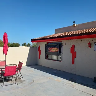 a patio with a table and chairs