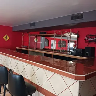 a red bar with black chairs