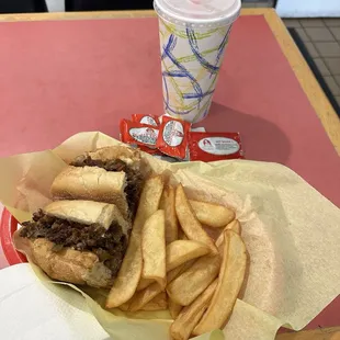 Philly cheesesteak, fries and a drink