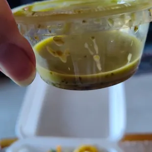 This is a standard Jello-shot cup with the dressing.  About one tablespoon of dressing for a large size salad.