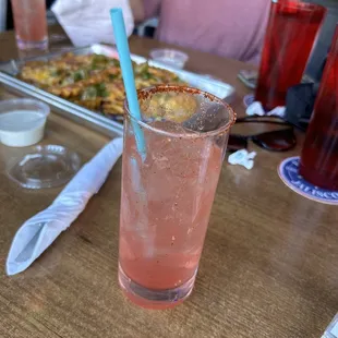 Sandia spritz with loaded cheese fries in the background!
