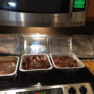 a variety of food in foil pans