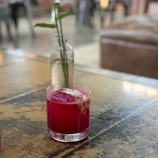 a flower in a vase on a table