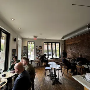 people sitting at tables in a coffee shop