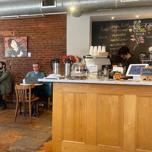 people sitting at tables in a coffee shop