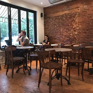 The cafe seating area - typically they have rotating artwork featured on the brick wall.