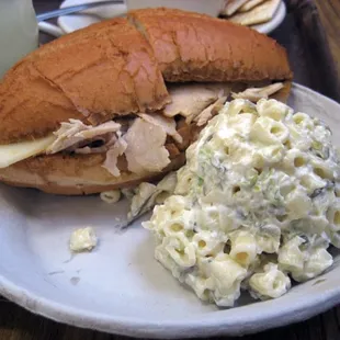 Turkey with swiss cheese sandwich and a side of macaroni salad