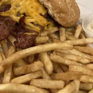 Bacon cheese burger with fries.