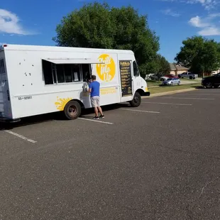 a man standing in front of a food truck