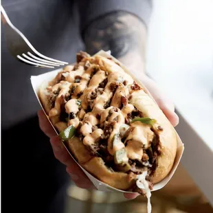 a person holding a hot dog