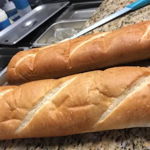 two long loafs of bread on a counter