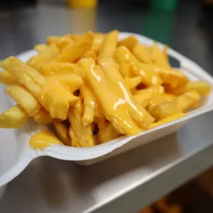 a container of cheese fries