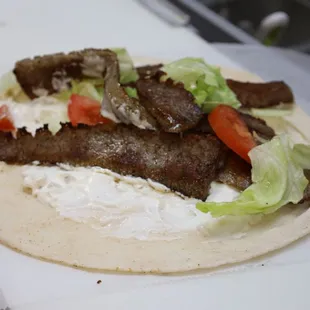 a pita filled with meat and lettuce